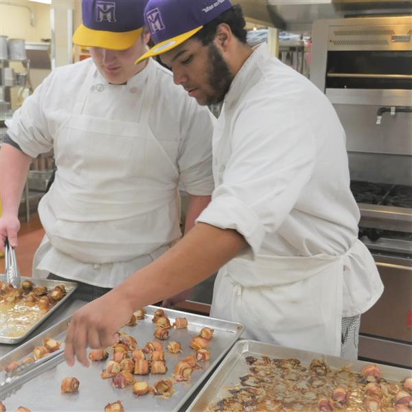 Two students prepping food